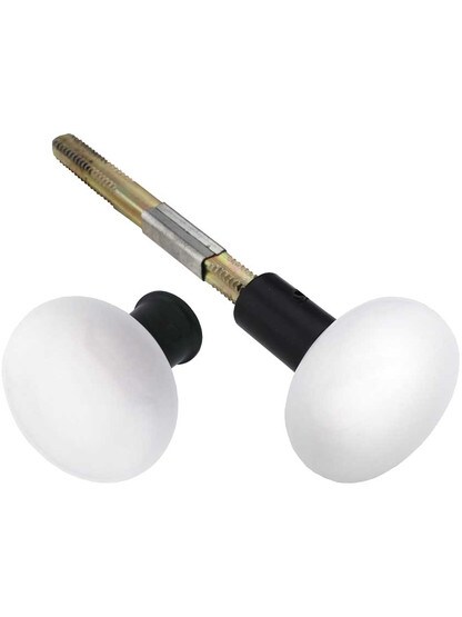 Pair of White Porcelain Rim Lock Knobs with Black Iron Shanks - 1 3/4 inch Diameter.